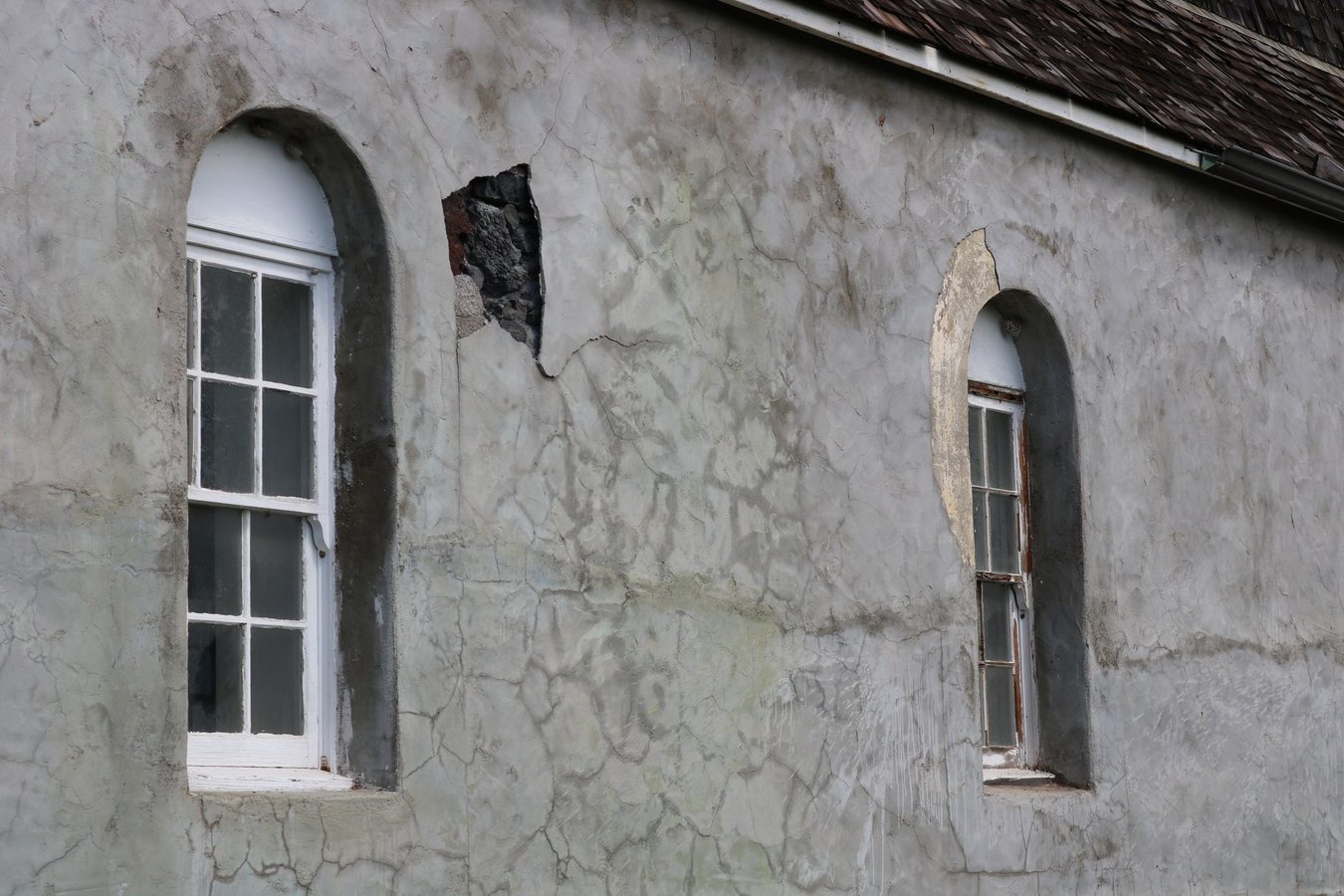 Before and after exterior building restoration showing water damage removal